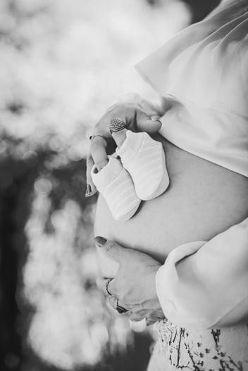 Pregnant woman holding her belly