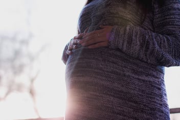 Pregnant woman with hands on her stomach